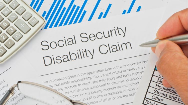 person filling out social security disability claim paperwork